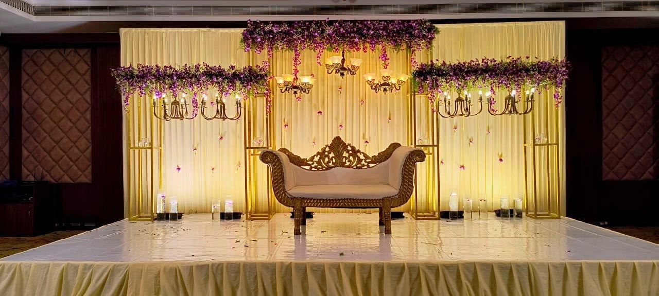 Reception stage with drapes and chandeliers